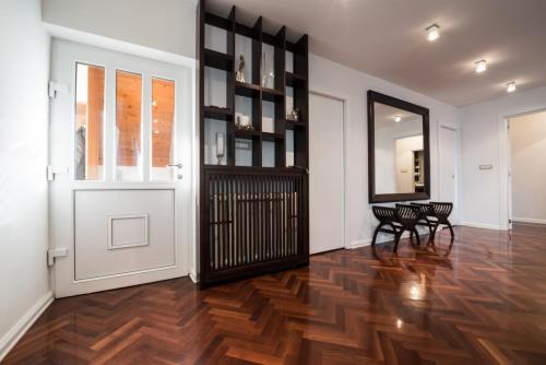 Spacious Anteroom Interior With Large Mirror And Brown Parquet